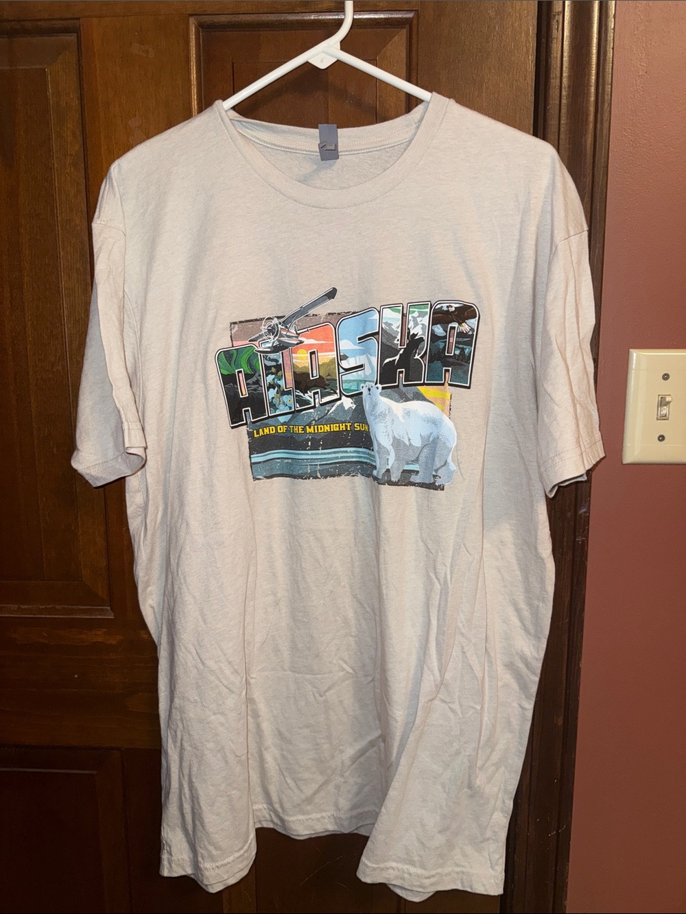 Next Level Apparel Beige Graphic Tee with Multicolor Surf Lettering